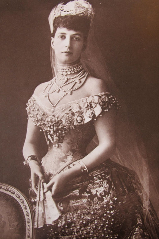 An Edwardian-era royal figure adorned with lavish pearl chokers
