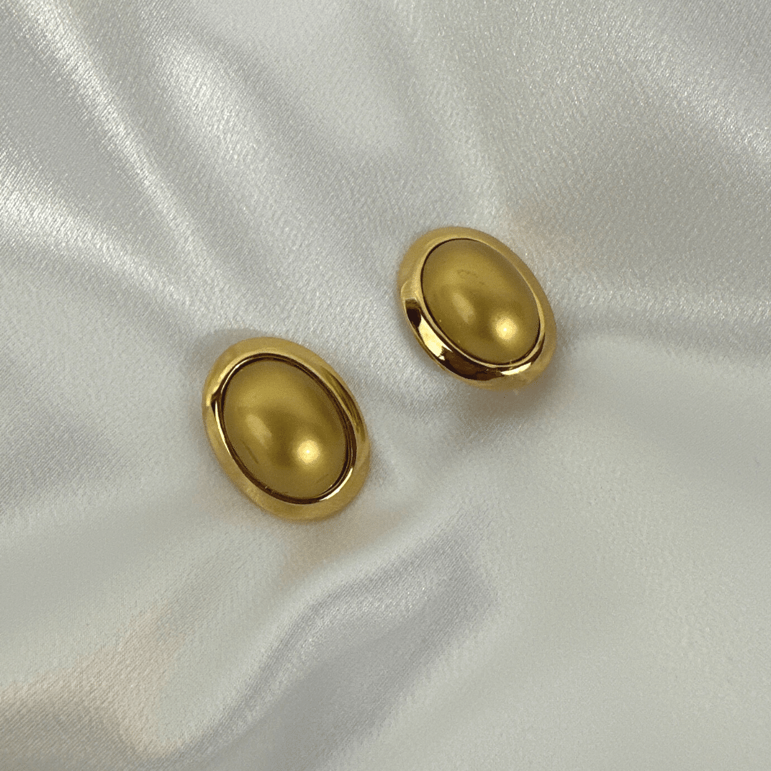 CINER Pearl-Shaped Gold Earrings, Signed, on satin background