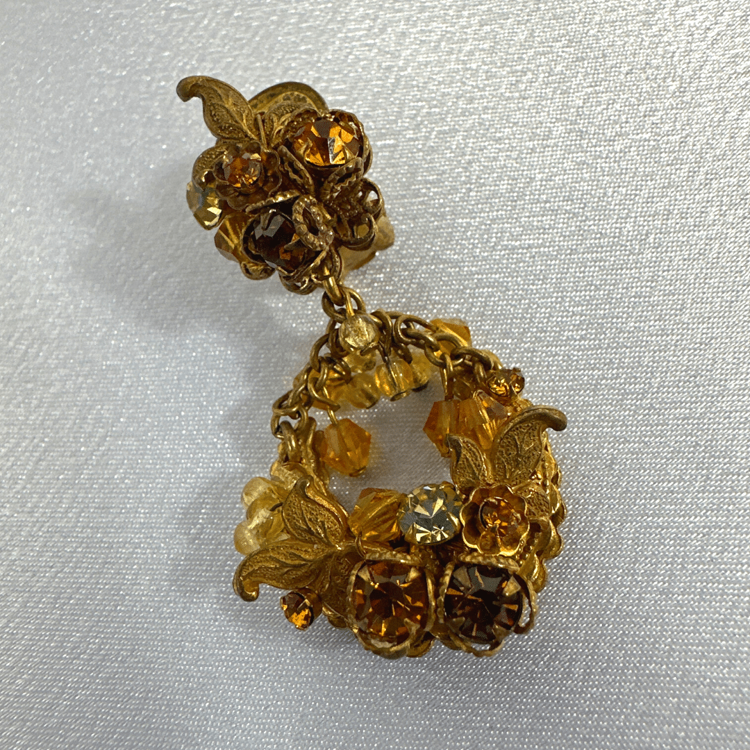 Demario Champagne Lucite Earrings -single earring - on satin background