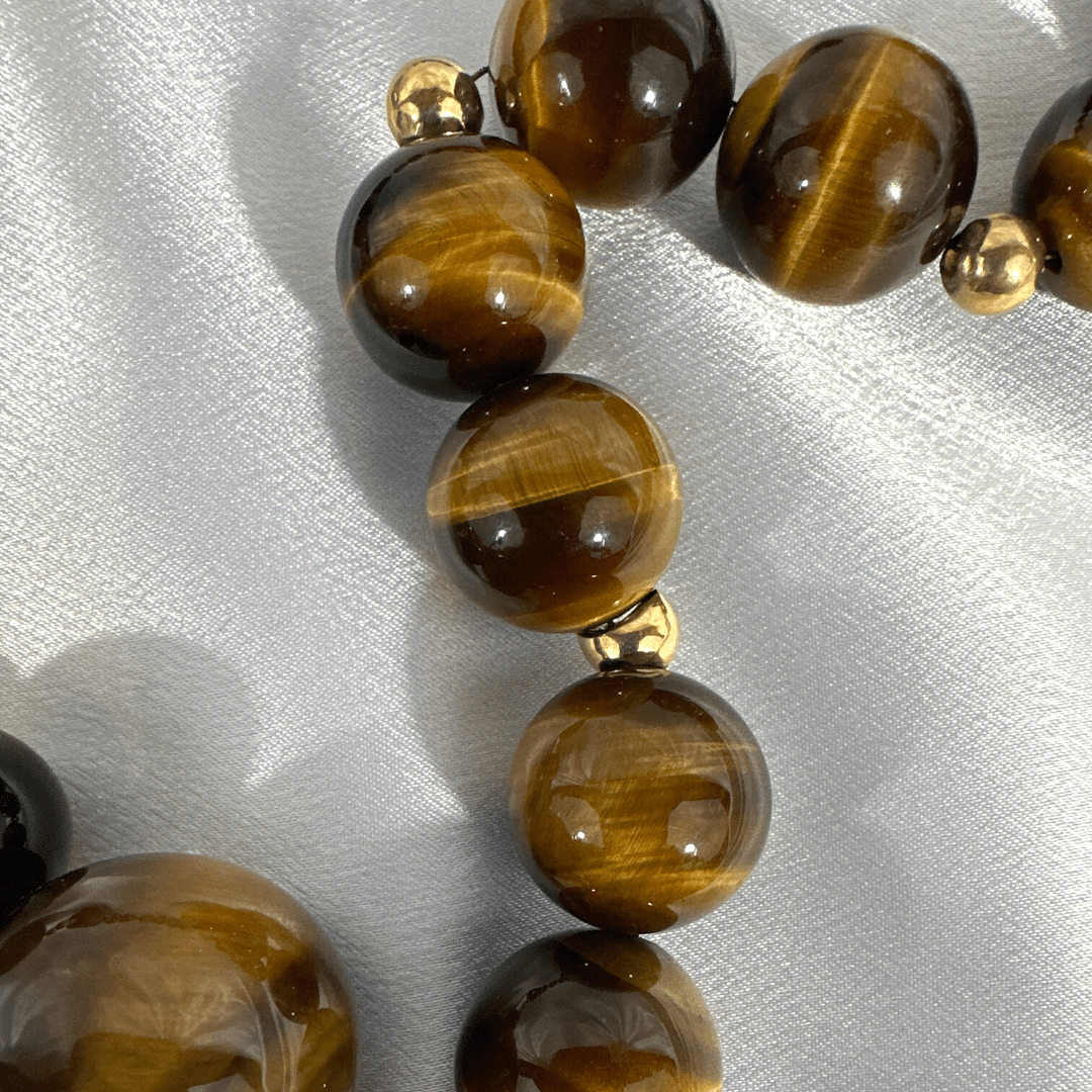 CINER Tiger Eye Necklace, on Satin Background