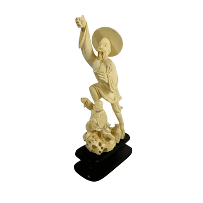 Vintage Chinese carved ivory statue depicting two men in traditional dress, finely detailed with a wide-brimmed hat and flowing robes.