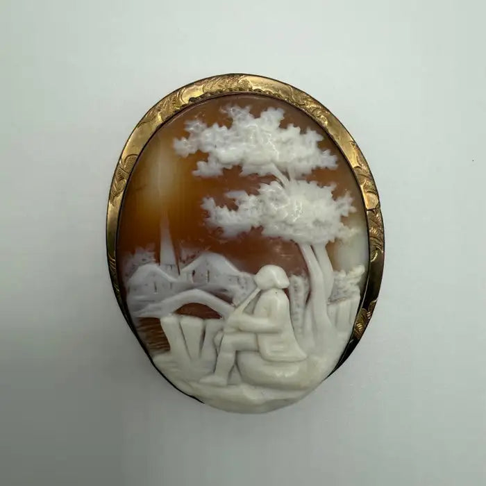 Victorian Shell Cameo Brooch Featuring Seated Flutist, Tree, and Bridge in Pastoral Scene, Late 19th Century