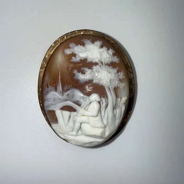 Victorian Shell Cameo Brooch Featuring Seated Flutist, Tree, and Bridge in Pastoral Scene, Late 19th Century