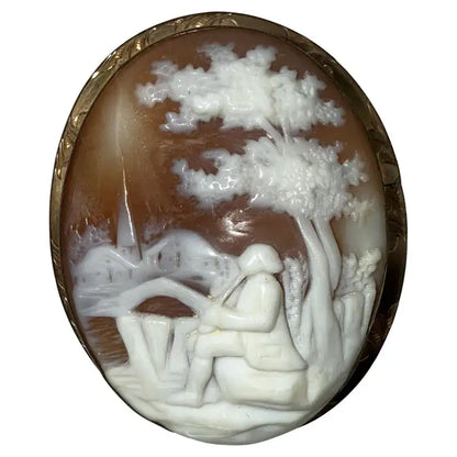 Victorian Shell Cameo Brooch Featuring Seated Flutist, Tree, and Bridge in Pastoral Scene, Late 19th Century